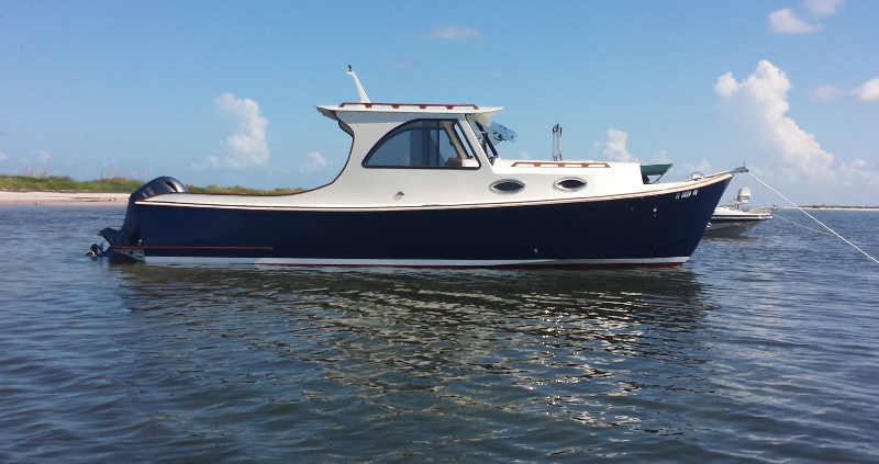 A newly completed 26' picnic boat-style outboard cruiser, on picnic trials